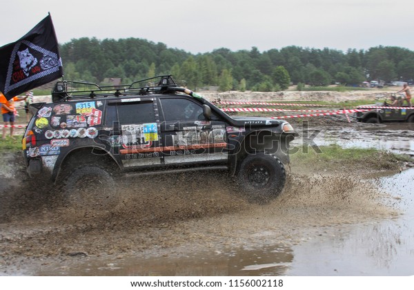 SUV splashing mud in big puddle,  Kyivska oblast,
Ukraine, summer 2015