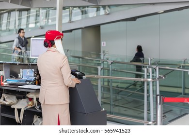 Suvarnabhumi Airport, Bangkok, Thailand ; Dec 12,2016 : Air Hostess Of Emirates Airline Waiting For Passengers Boarding The Airplane At The Terminal Gate.