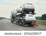 SUVs being delivered on two-level trailer truck