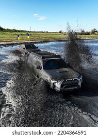 SUVs Stuck In The Middle Of The River In The Swamp.  Can't Leave.  Off-road Competitions.  Drone View.  One Truck Is Trying To Get Another Out Of The Water.