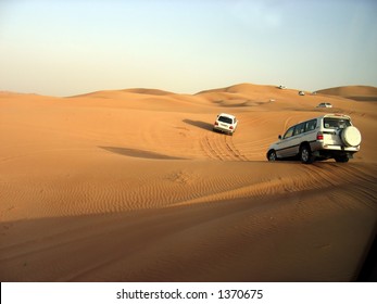 SUVs Trek Across The Desert Dunes