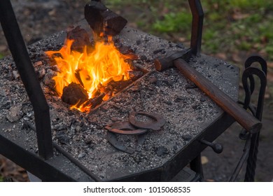 Suzdal, Russia - Traditional workplace of a blacksmith with a forge, hammer and horseshoes. - Powered by Shutterstock