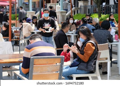 SuzhouChina-April 2020: Life Returns To Normal In Many Cities In China. Crowd Of People Sitting At Outdoor Restaurant, Wearing Protective Mask To Prevent Coronavirus