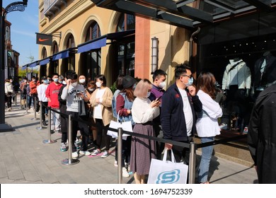 SuzhouChina-April 2020: Life Returns To Normal After Coronavirus In China. Crowd Of People Wearing Protective Mask, Waiting Outside NIKE Store For Shopping. Retaliatory Consumption Concept