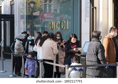 Suzhou.China-Jan.2021: Chinese customers in face mask to prevent coronavirus, waiting outside GUCCI's store for shopping