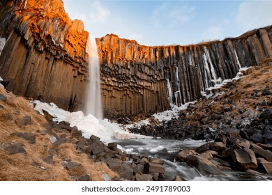 Svartifoss Waterfall in Winter landscape with ice and snow - Powered by Shutterstock