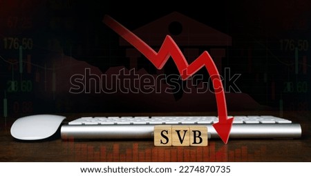 SVB (Silicon Valley Bank) with keyboard and mouse, stock market chart, and red arrow pointing down. biggest bank in Silicon Valley, stocks fall.                      