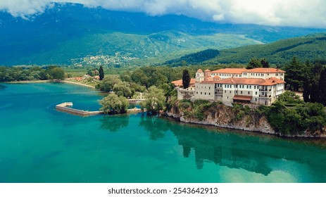 Sveti Naum Monastery in Macedonia overlooking tranquil waters and scenic mountains in a picturesque landscape - Powered by Shutterstock