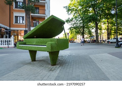 SVETLOGORSK, RUSSIA - July 3th, 2021: Sculpture Of A Grand Piano With Open Lid Made Of Green Artificial Grass, Urban Topiary, No People