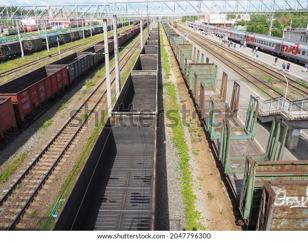 Svir, Russia August 6, 2021. Freight trains and\
wagons from above. Railroad on a summer day. Transportation, cargo,\
logistics and business process. Empty metal wagons. International\
cargo transport