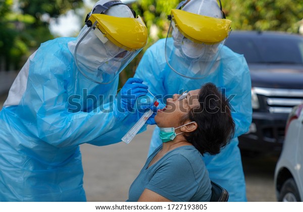 \
Swabs test, Doctors in protective clothing\
performed a nasal mouth swabs congestion. From the patient to test\
for Coronavirus Covid-19\
infection.