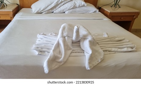 Swan Folded From White Towels On Bed In An Old Hotel Room, Top View, Turn Down Service