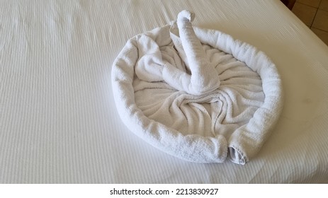 Swan Folded From White Towels On Bed In An Old Hotel Room, Top View, Turn Down Service