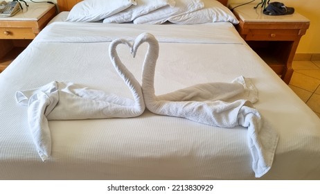 Swan Folded From White Towels On Bed In An Old Hotel Room, Top View, Turn Down Service