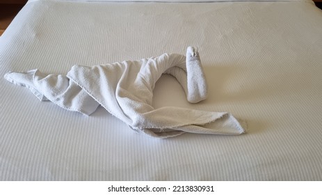 Swan Folded From White Towels On Bed In An Old Hotel Room, Top View, Turn Down Service