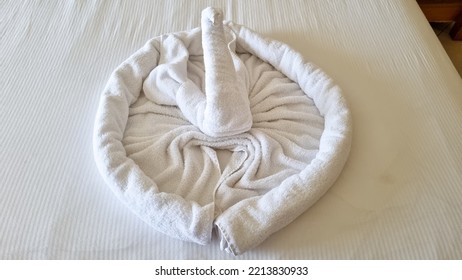 Swan Folded From White Towels On Bed In An Old Hotel Room, Top View, Turn Down Service