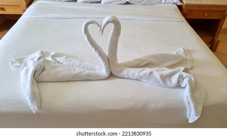 Swan Folded From White Towels On Bed In An Old Hotel Room, Top View, Turn Down Service