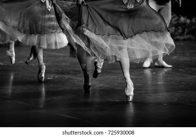 Swan lake ballet. Ballerina feet on stage. Black and white photography.