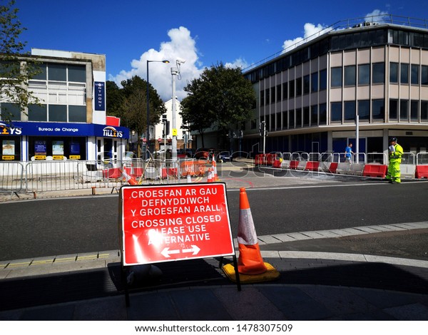 Swansea, UK: August, 2019: A bilingual information sign\
on the Kingsway. The on-going road work project is back on track\
after construction company Dawnus went into administration in March\
2019. 