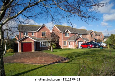 Swansea, UK: February 10, 2019: Street View Of A Four Bedroom Detached Family House With Similar Houses Next Door. Middle Class Housing Development With Large Front Gardens. 