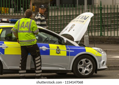 SWANSEA, WALES - JULY 2018: Mechanic From The AA Attending A Broken Down RAF Police Patrol Car In Swansea, Wales.