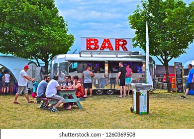 Swansea, West Glamorgan / Wales UK -7/1/2018: People enjoying food &  drink from Retro style Airstream caravans converted to bar and fast food outlet at Swansea Air Show.