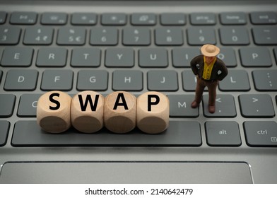 swap is a derivative contract through which two parties exchange the cash flows or liabilities from two different financial instruments. The word is written on keyboard background