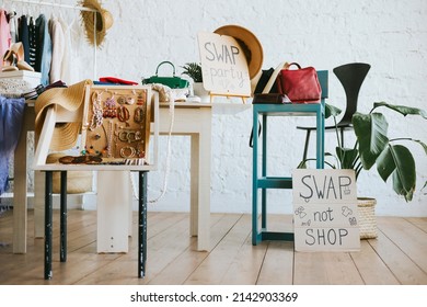 swap party for try on clothes, bags, shoes and accessories, friends change clothes, second hand and zero waste life, eco-friendly approach to consumption, clothes hanger in loft interior - Shutterstock ID 2142903369