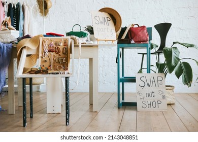 swap party for try on clothes, bags, shoes and accessories, friends change clothes, second hand and zero waste life, eco-friendly approach to consumption, clothes hanger in loft interior - Shutterstock ID 2143048851