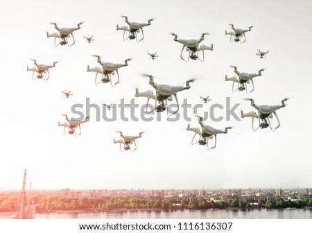 Swarm of drones flying over the city 