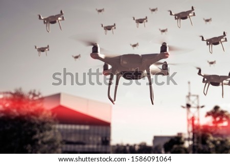 Swarm of drones surveying, flying over city 