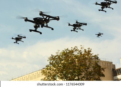 Swarm Of Quadcopters Drones In The Air Over City. Army Invasion