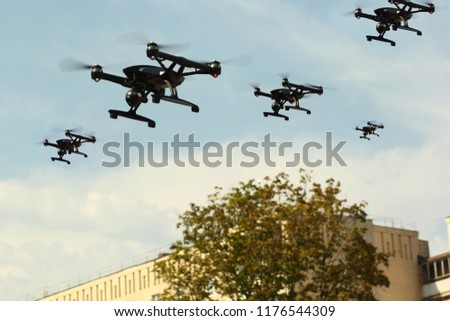 Swarm of Quadcopters Drones In The Air Over City. Army invasion