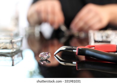 Swarovski crystal. Woman hands a jeweler while working on jewelery