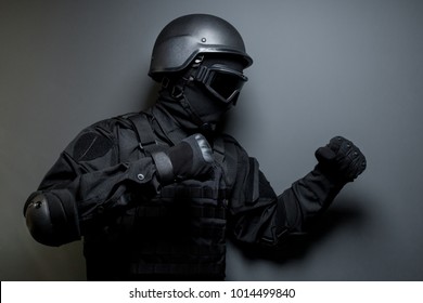 SWAT In Black Uniform, Face Mask And Bulletproof Vest. Russian Special Forces. Tactical Helmet Vest Goggles. Spec Ops Riot Police Officer Defense And Protection Of Law Enforcement Officers.