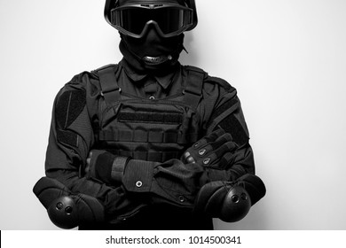SWAT in black uniform, face mask and bulletproof vest.Special forces.Tactical helmet vest goggles.Spec ops Riot police officer Defense and protection of law enforcement officers.Black and white photo