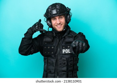 SWAT Caucasian Man Isolated On Blue Background Making Phone Gesture And Pointing Front