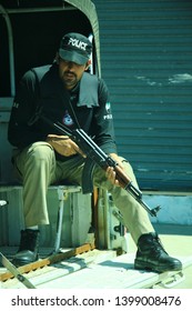 Swat, Khyber Pakhtunkhwa / Pakistan - April 12 2016 - Policeman Is On Duty Of For Tourist Protection And Sitting In Police Car With Rifle