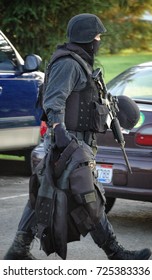 A SWAT Officer Takes His Gear Closer To The Scene Of A Hostage Negotiation.