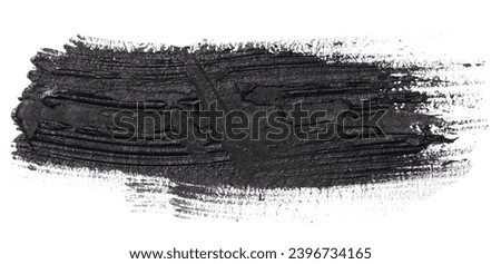 Swatch of black smudged acrylic paint isolated on white background, close up