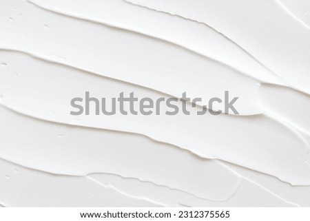 Swatch of white cream texture, cosmetics for face and body on a isolated light grey background. Putty