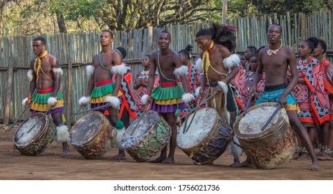 SWAZILAND, MANTENGA - July 2019 Traditional Swaziland men singing and dancing with traditional attire/clothing,  group of male Swazi dancers performing high energy war dance, the tourist season.