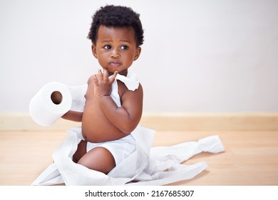 I Swear The Dog Did It. Shot Of A Cute Baby Boy Entangled In A Roll Of Toilet Paper.