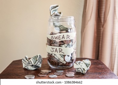 Swear jar to prevent swearing, filled with money