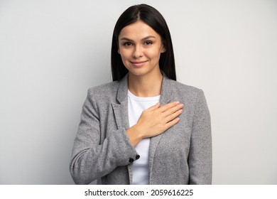 I swear. Portrait of responsible serious businesswoman in business suit holding hand to take oath, promising to be honest, telling truth, pledging allegiance. Studio shot isolated on white background 