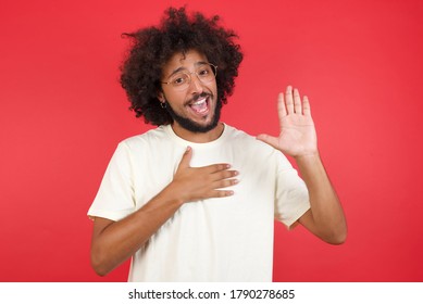 I Swear, Promise You Not Regret. Portrait Of Happy, Sincere Young Man Raising One Arm And Hold Hand On Heart As Give Oath, Pledge, Telling Truth, Want You To Believe, Standing Over Yellow Background