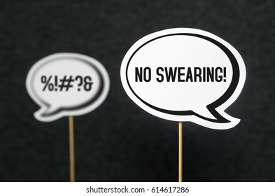Swearing, cursing and bad language or behaviour in school, work or life. Speech bubble telling the other not to swear. Concept of no dirty words and teaching good manners with speech balloons. 