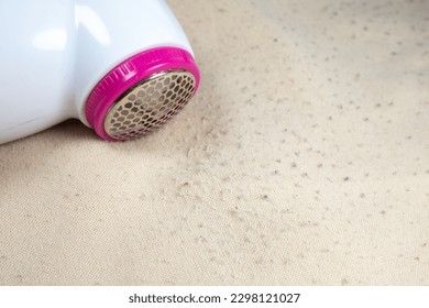 Sweater pilling portable machine. Clothes fabric shaver. Hair ball trimmer. Electric remover of fluff wool ball, fuzz, lint. - Shutterstock ID 2298121027