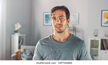 Sweating Muscular Athletic Fit Man in Grey Outfit is Posing After a Workout at Home in His Spacious and Sunny Living Room with Minimalistic Interior. - Powered by Shutterstock