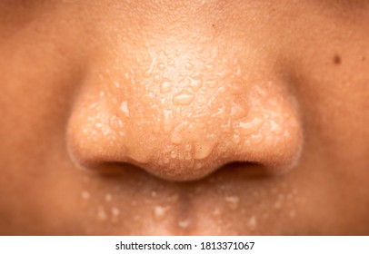 Sweating on the nose and face.Close up face with sweat ware drop on face.